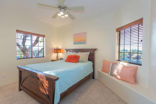 a bedroom with a bed and a ceiling fan at Spectacular Views, Heated Pool, and Outdoor BBQ in Tucson