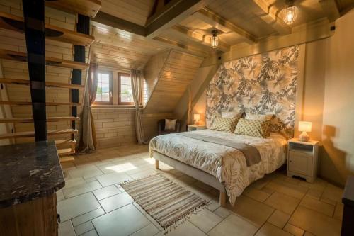 a bedroom with a large bed in a room with wooden ceilings at Logement 1 à 6 personnes---Le Kelsch in Marlenheim