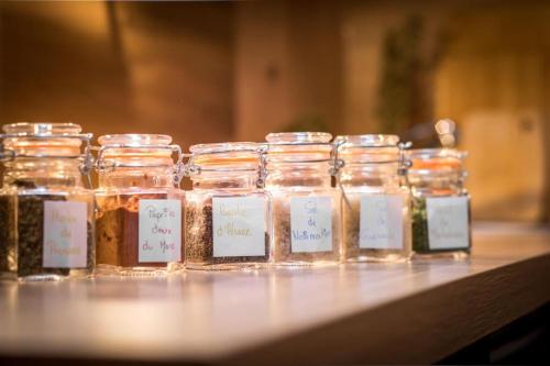 a group of jars of honey sitting on a table at Le Kelsch, loft duplex 130m2, proche vignoble in Marlenheim