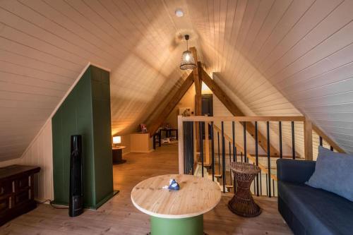 a living room with a couch and a table at Le Kelsch, loft duplex 130m2, proche vignoble in Marlenheim