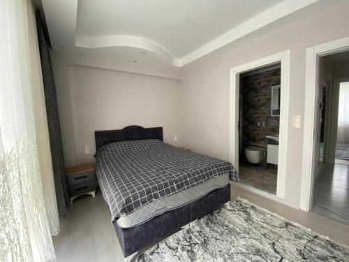 a bedroom with a bed in a room at 2+1 MUHTEŞEM TATİL EVİ in Dalaman