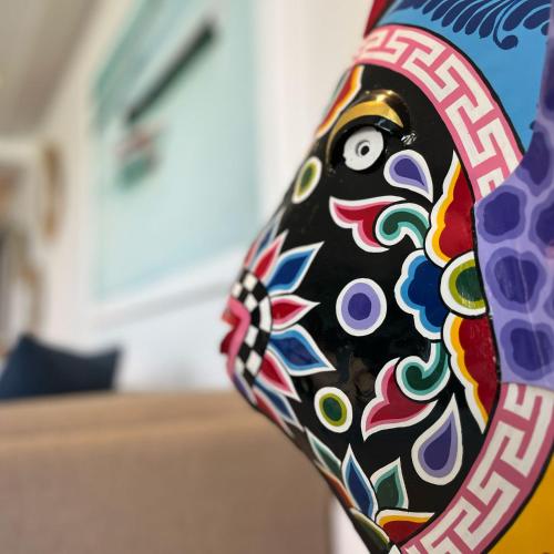 a colorful vase with a face on it at Blue Ocean Suites & Apartments in Trou dʼ Eau Douce