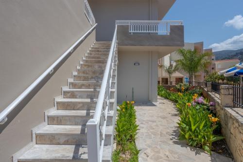 a staircase leading up to a house with flowers at Amara Seaside by Estia in Malia