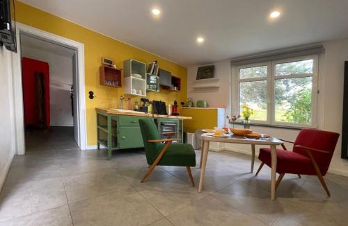 een keuken met gele muren en een tafel en stoelen bij Naturferienhaus Klein Rosenburg für 2 Personen in Klein Rosenburg