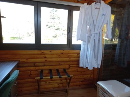 a robe hanging in a room with a window at Windsong Living The Nest in Krugersdorp