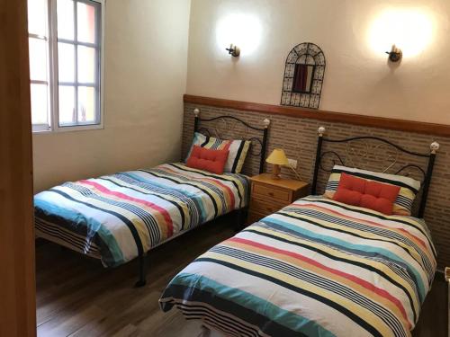 Katil atau katil-katil dalam bilik di Apartamentos la Barranquera