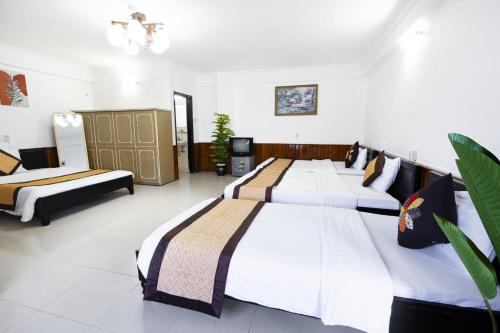 a bedroom with three beds in a room at Casablanca Hotel in Hue