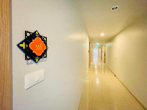 a hallway with a sign on a wall at Nara lahabana in Hua Hin