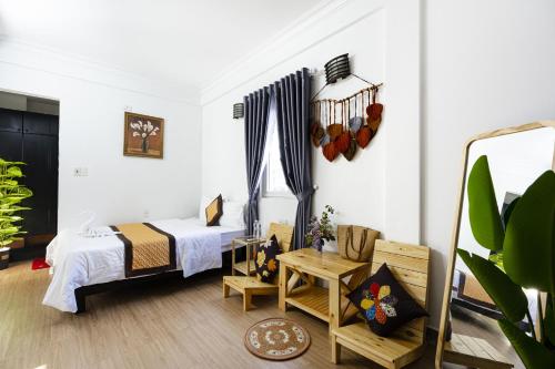 a bedroom with a bed and a table and a window at Casablanca Hotel in Hue