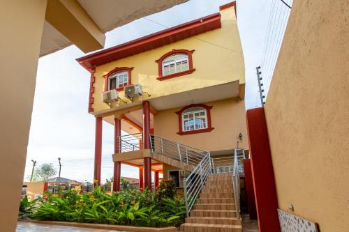 a building with a staircase in front of it at NKA Properties in Apenkwa