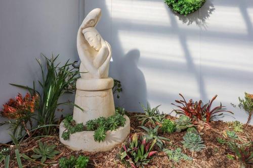 a statue of a bunny in a garden at Logans Beach Apartments - BeachHouse in Warrnambool
