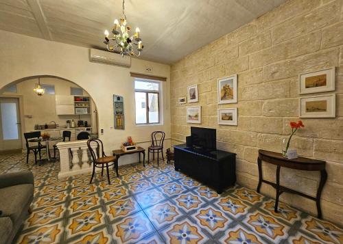 a living room with a couch and a dining room at Dar Garigor in Cospicua