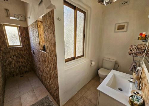 a bathroom with a sink and a shower and a toilet at Dar Garigor in Cospicua