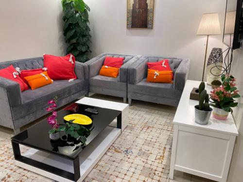 a living room with two couches and a coffee table at صالة وغرفتين نوم دخـول ذاتي in Al Kharj