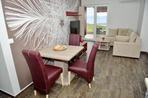 a dining room with a table and chairs and a living room at Velestovo House in Ohrid
