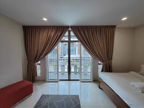 a bedroom with a bed and a large window at Malacca City Center Town House by 360HOME in Melaka