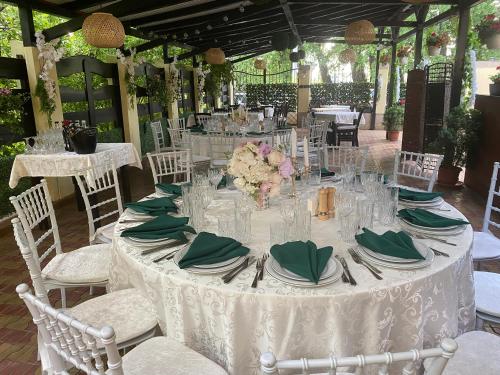 a white table with plates and napkins on it at Cazare Plopii fara Sot in Iaşi