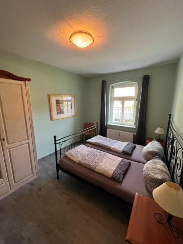 a bedroom with a bed and a window at Quartier am Nationalparkhaus in Bad Schandau