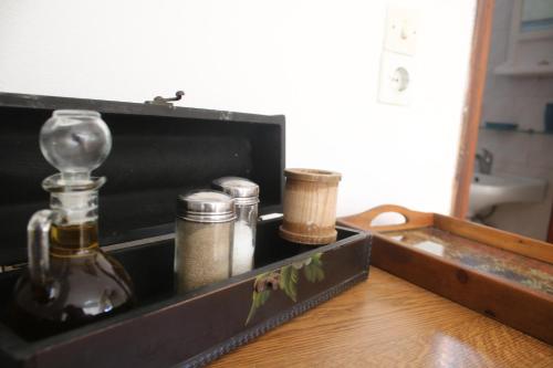 a wooden box with bottles on a wooden table at Volcano View Nisyros in Mandrákion