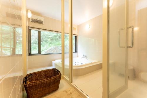 a bathroom with a shower and a sink and a tub at HAYATO HAKONE GUEST HOUSE in Hakone