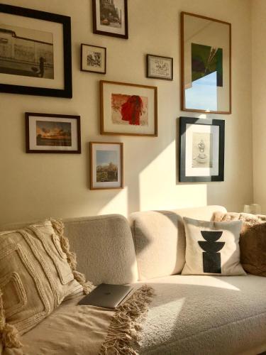 - un salon avec un canapé et un ordinateur portable dans l'établissement LuxeLevallois chic stay with balcony 800 meters from Paris, à Levallois-Perret