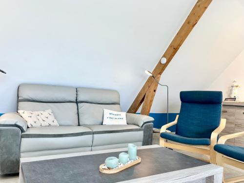 a living room with a couch and a chair at COC - Les Sables Blancs in Wissant