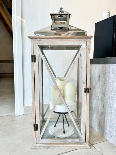 a glass box with a chair inside of it at COC - Les Sables Blancs in Wissant