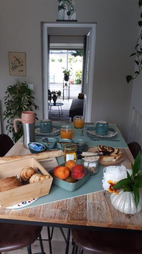 a table with a bunch of food on it at Chambre d'hôtes Les Hortensias in Gelos