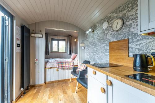 a kitchen and a bedroom with a bed at The Little John Petite Cosy log Cabin Romantic Stay Sleeps 2 Near Sherwood Forest at Fairview Farm Nottingham set in 88 acres in Blidworth