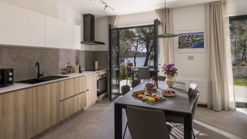 a kitchen with a table with a plate of food on it at Mare Solis Pinea in Mali Lošinj