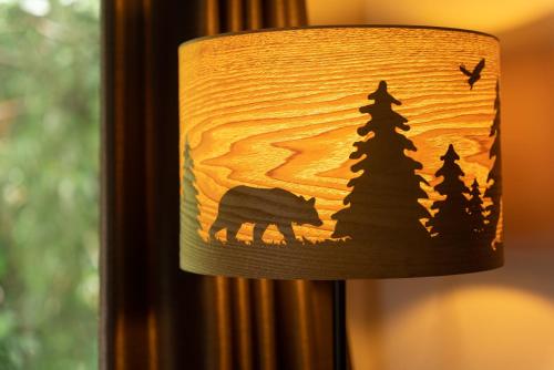 a lamp shade with a wolf and trees on it at HAYATO HAKONE GUEST HOUSE in Hakone