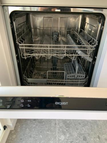 an open dishwasher with its dishes in it at #2800ourhome 202 in Mechelen