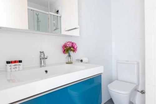 a bathroom with a sink and a toilet at Lodging Apartments Guell Gaudi in Barcelona