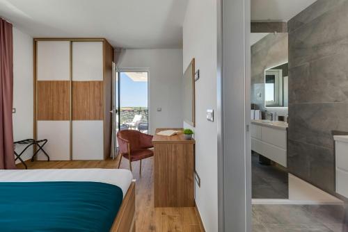 a small bedroom with a bed and a kitchen at Villa Kate ZadarVillas in Knežević