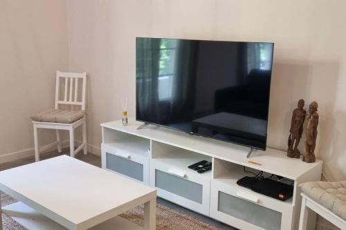 a living room with a television on a white entertainment center at 2 pièces au centre d'Antibes. in Antibes