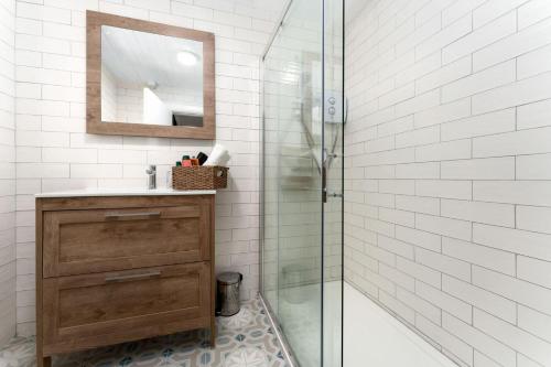 a bathroom with a shower and a sink and a mirror at Cottage 446 - Letterfrack in Letterfrack