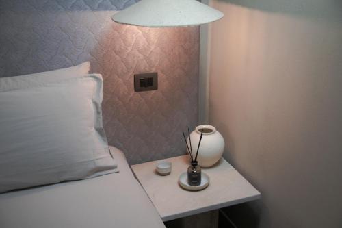 a bedroom with a bed and a lamp on a table at The Sanctuary Urban Retreat in Rome
