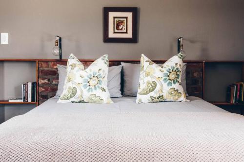a bedroom with a bed with pillows on it at Groenvlei Cottage in Porterville
