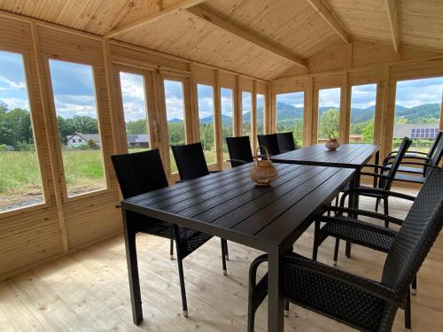 a dining room with a large wooden table and chairs at Apartmány Pod Vrchem Kytlice 71 in Kytlice