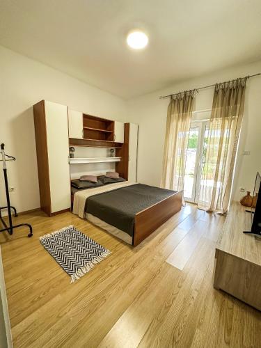 a large bedroom with a bed and a fireplace at Apartments Dent in Umag