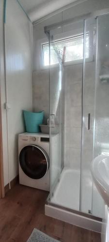 a bathroom with a shower and a washing machine at Zawady Oleckie- Ostoja in Kowale Oleckie