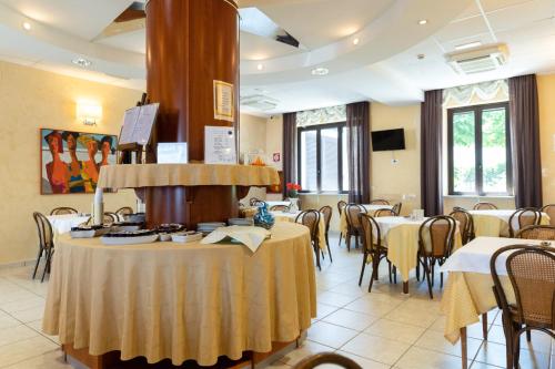 a dining room with tables and chairs and a room with at Hotel La Bussola in Ortona