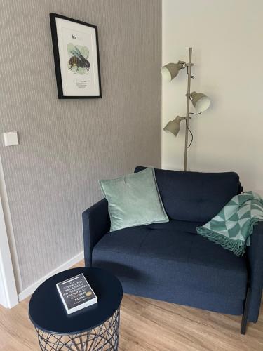 a living room with a blue couch and a table at Hotel Haus Erholung in Cochem