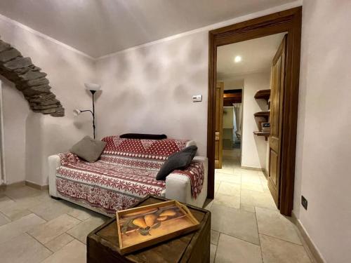 a bedroom with a bed and a table in it at Alla Ricerca della Serenità in Arvier