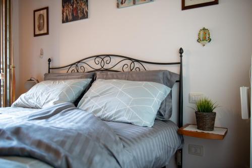 a bed with blue sheets and pillows in a bedroom at Poggio Valeria, relax in Toscana in Saturnia
