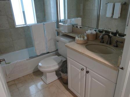 a bathroom with a toilet and a sink and a mirror at The Fritz Hotel in Miami Beach