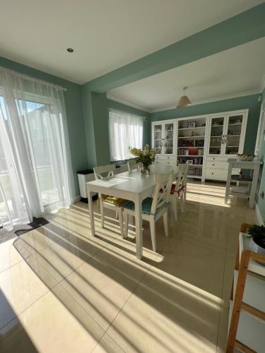 a dining room with a white table and chairs at Adaline House Dublin in Dublin