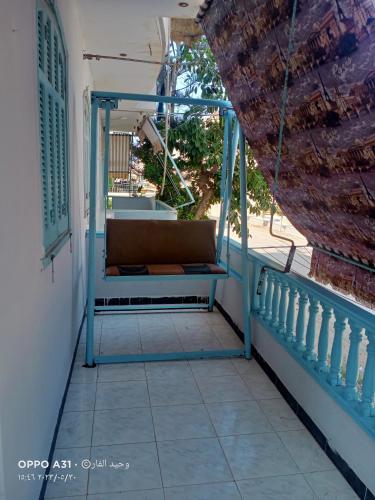 a porch with a bench on the side of a house at الوحيد للعقارات in Ras El Bar