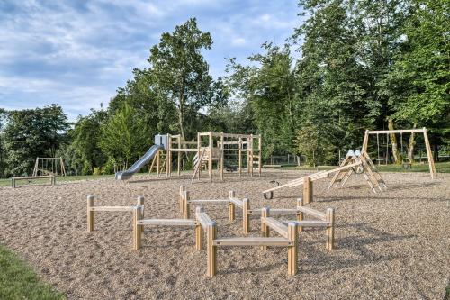 an empty playground with a slide and swings at Rixos-Prykarpattya Resort in Truskavets