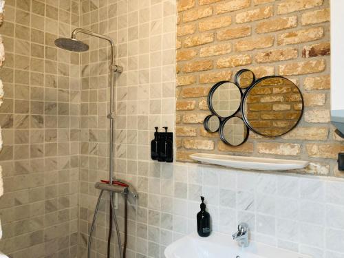 a bathroom with a sink and a mirror on the wall at B&B with or without De Schuur in Zierikzee